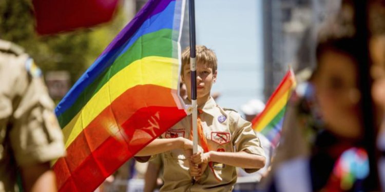 A Boy Scout carries a rainbow