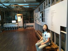 Ambassador Girl Scout Lauren Wong sits in front of JANM's Common Ground exhibition.